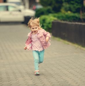 little cute girl running the street